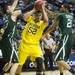 Michigan sophomore Jordan Morgan holds the ball from Ohio University junior Ivo Baltic and sophomore Jon Smith in the first half of the second round of the NCAA tournament at Bridgestone Arena in Nashville, Tenn.  Melanie Maxwell I AnnArbor.com